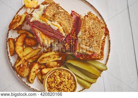 Reuben sandwich. Classic traditional American sandwich. Pastrami and corned beef on grilled bread