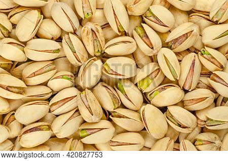 Roasted And Salted Pistachio Seeds With Shell, Background, From Above. Snack Food, Made From Fruits 