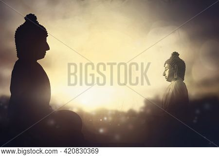 Vesak Day Concept: Silhouette Buddha On Golden Sunset Background