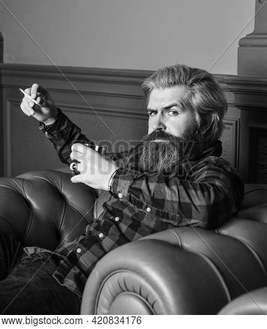 Smoke Cigarette While Drink Brandy Or Cognac. Hard Beverage For Real Men. Brutal Man Drinking Whiske
