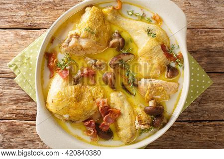 Stewed Chicken In White Wine With Cream, Bacon And Mushrooms Close-up In A Saucepan On The Table. Ho