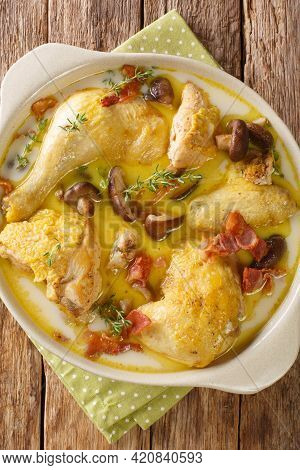 French Coq Au Riesling Chicken In Wine Recipe Closeup In The Bowl On The Table. Vertical Top View Fr