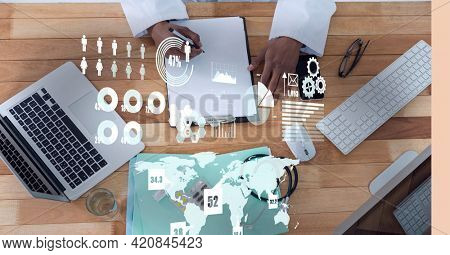 Digital interface with data processing over mid section of doctor taking notes. computer interface and medical research technology concept