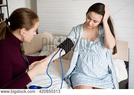 Measuring The Pressure Of A Pregnant Woman At Home. Poor Well-being Of A Pregnant Woman.