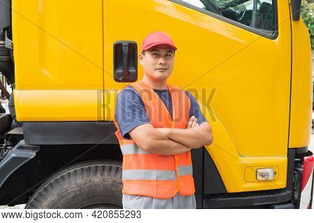 Asian Truck Driver In Safety Clothes Smile Confident. Happy Owner Transportation Business Stand Prou