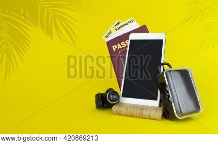Air Travelling Concept, Passport, Boarding Pass, Suitcases And Smartfone On Yellow Background.