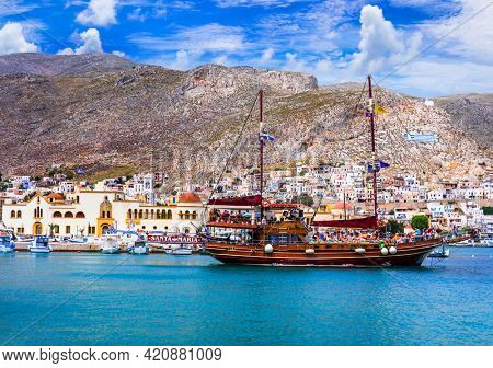 Greek island travel, island hopping with traditional turkish touristic boat. Kalymnos island, Pothia town port may 2019