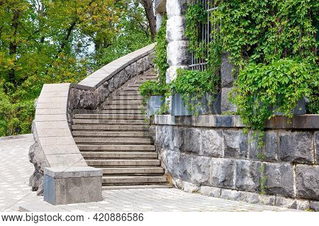 A Stone Staircase With Massive Steps Rises Up Around The Old Wall Of The Ancient Castle Against The 