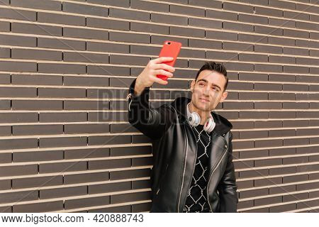 Young Man Taking A Selfie Or A Photo For His Social Networks. Lifestyle And Influenzer Concept