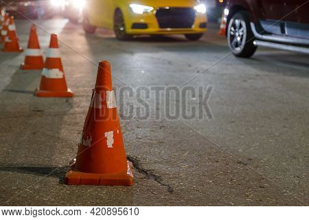 Orange Traffic Cones Row On Night City Asphalt - Close-up With Selective Focus
