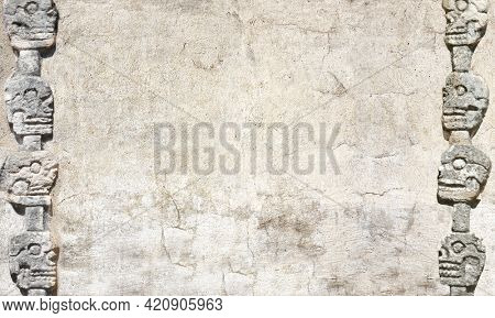 Horizontal banner with stone wall texture and bas-relief carving with human skulls, pre-Columbian Mayan civilization. Day of the Dead (El Dia de Muertos) holiday background. Copy space for text