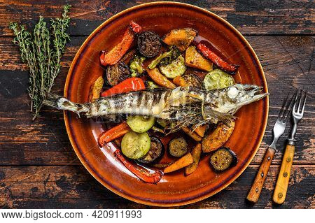 Baked Whole Icefish With Grilled Vegetables. Dark Wooden Background. Top View