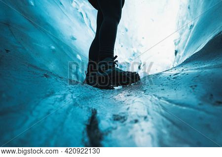 Female explorer in the ice cave, Iceland