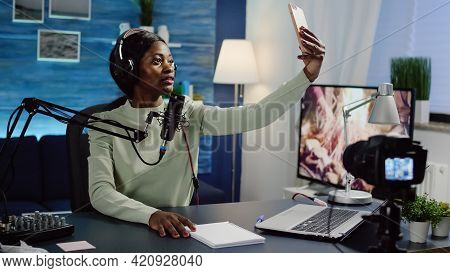 Black Woman Vlogger Taking Selfie Using Smartphone During Streaming Live Content For Social Media. I