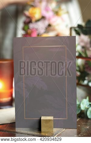 Card mockup by bouquet of flowers on a wooden table