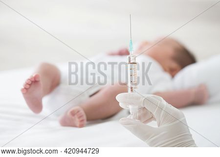 Syringe With Blur Baby Background. Vaccine Antivirus For Infant 
Concept