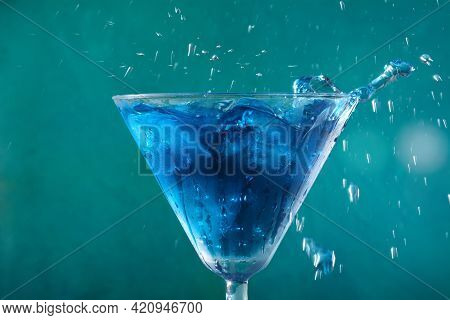 Blue Lagoon Cocktail With Blue Curacao Liqueur, Vodka, Lemon Juice And Soda, Decorated With Lemon Sl