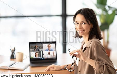 Online Education Concept. Happy Young Female Student Having Online Video Call With Her Fellow Studen