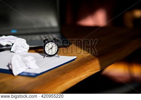 Modern Workplace, Wooden Office Desk In Hardlight, Sunligt With Clock, Sheet Of Paper