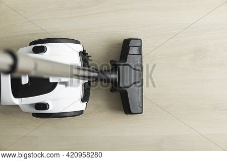 Bagless Cyclone Vacuum Cleaner On A Laminate. Electrical Apparatus That By Means Of Suction Collects