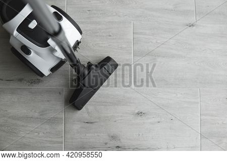 Bagless Cyclone Vacuum Cleaner On A Grey Tile. Electrical Apparatus That By Means Of Suction Collect