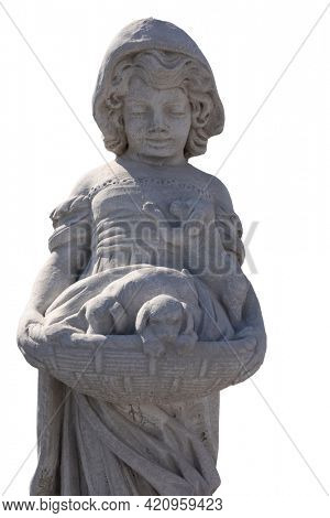 Close up of stone sculpture of girl holding puppies in basket on white background. art and classical style romantic figurative stone sculpture.