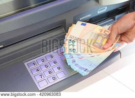 Hand With A Lot Of Money Just Withdrawn From The Atm Machine And The Numbers On The Numeric Keypad T