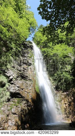 Bubbling Water Of The Great Waterfall In The Middle Of The Lush Forest