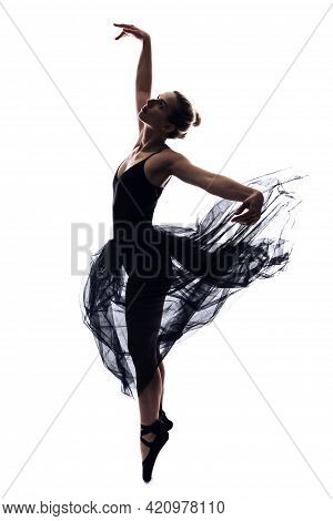 Professional Female Ballet Dancer In Body Suit And Flying Black Dress Posing In Dance In Various Pos
