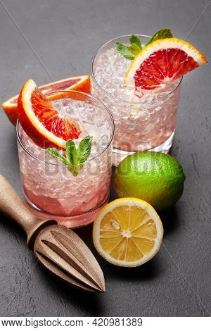 Fresh citrus lemonade with mint and crushed ice. Bood orange, lime, lemon and juicer