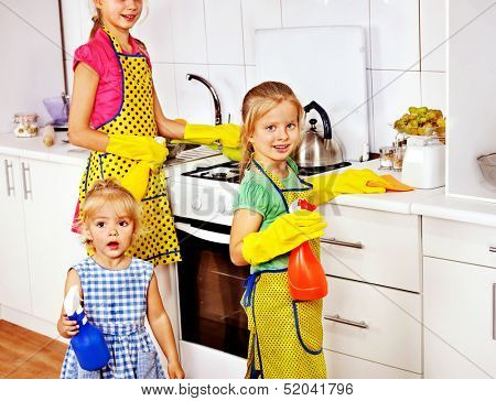 Children little girl cooking at kitchen.