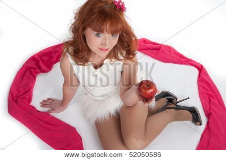The Girl Sits On A White Background With An Apple