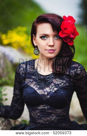 Beautiful girl with red flower