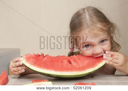 Two-year-old girl eating watermelon with cheerful faces