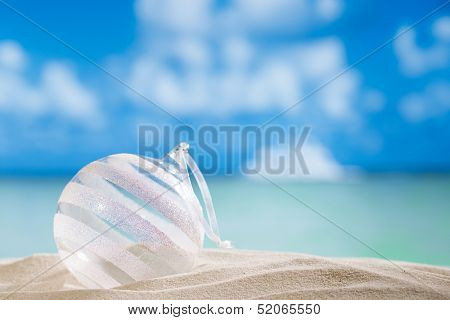 glitter christmas glass ball on  beach with seascape background