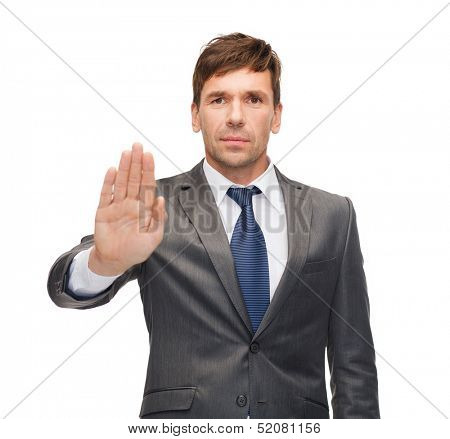 business and office, ban, veto, warning concept - attractive buisnessman making stop gesture