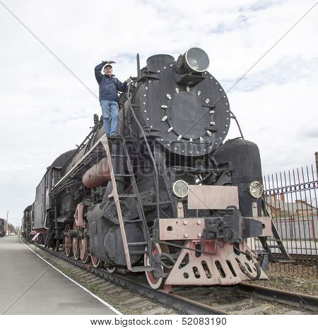 The Machinist Of A Steam Locomotive Looks Afar
