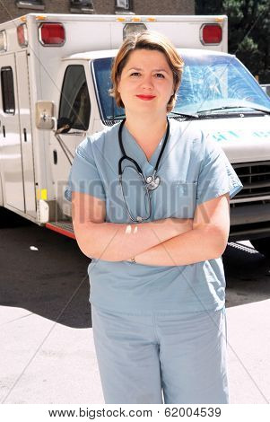 Female doctor or paramedic in front of an ambulance