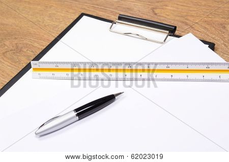 Clipboard, Pen And Straightedge On The Table
