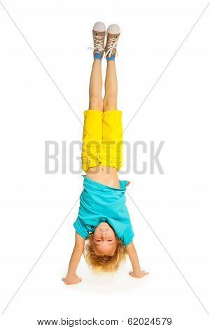 Blond boy standing on hands