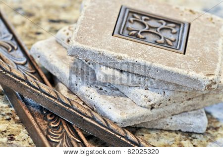 Ceramic tiles and borders for backsplash close up on a granite surface