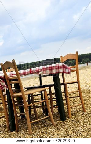 Dining table and chairs set outside on a beach