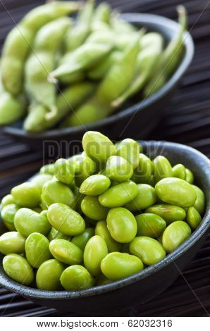 Edamame soy beans shelled and with pods in bowls