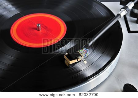 Vinyl record spinning on turntable close up