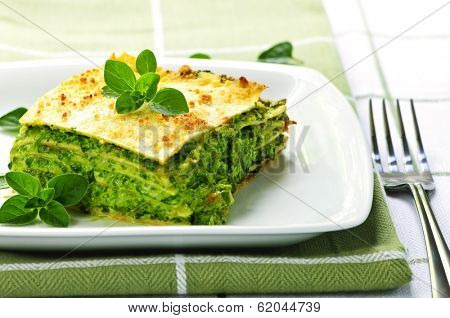 Serving of fresh baked vegeterian spinach lasagna on a plate