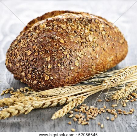 Loaf of fresh baked multigrain bread with grain ears