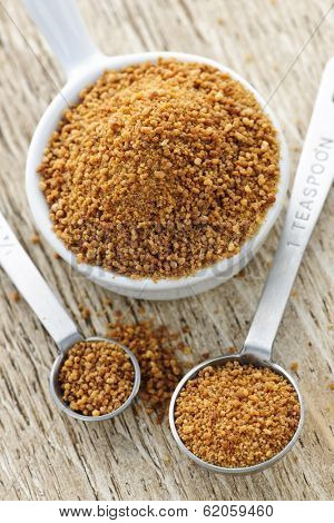 Organic coconut palm sugar in measuring spoons