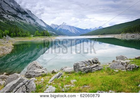 Mountains reflecting in Medicine Lake in Jasper National Park, Canada
