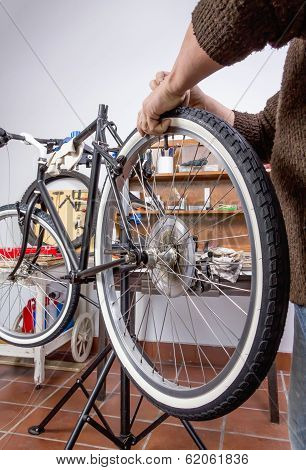 Real bicycle mechanic repairing custom fixie bike