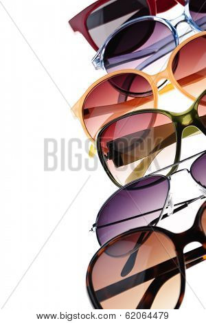 Different styles of tinted sunglasses on white background